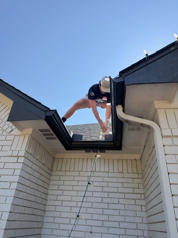 Installing Christmas lights on rooftop during training